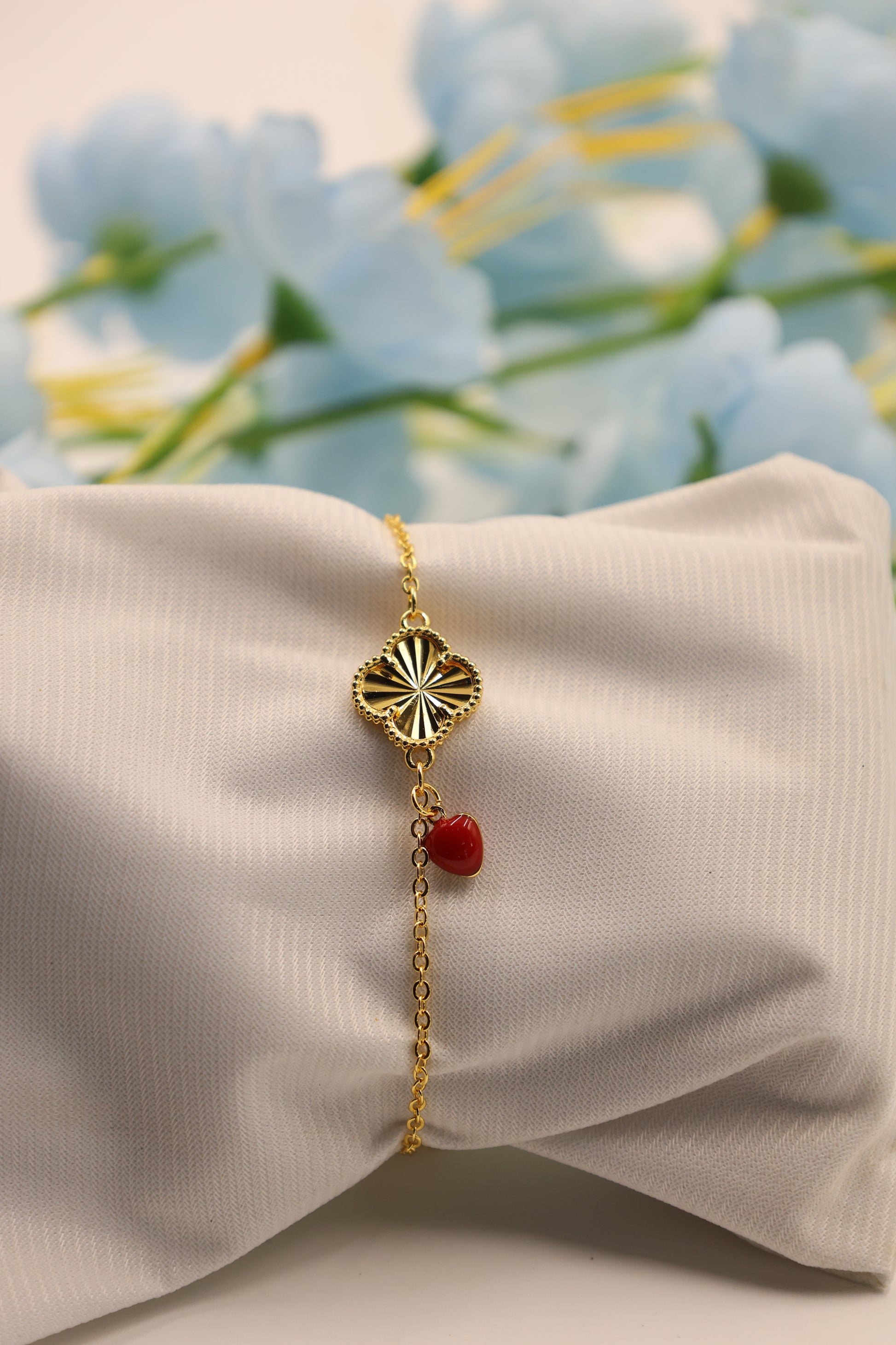 Golden Clover Link Bracelet with Red Charm Drop – Everyday Elegance Edition